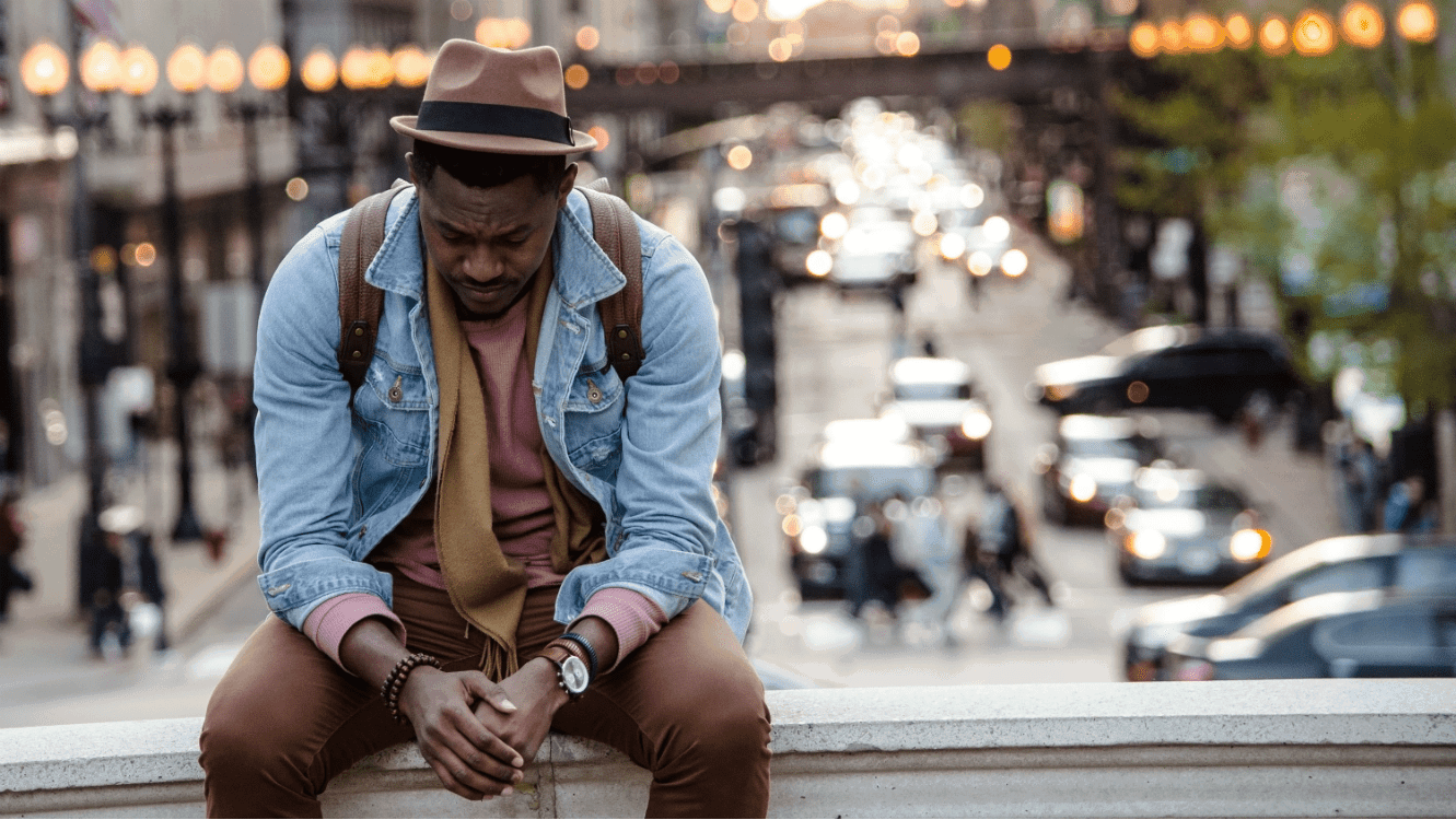 Man sitting feeling down because he's unemployed