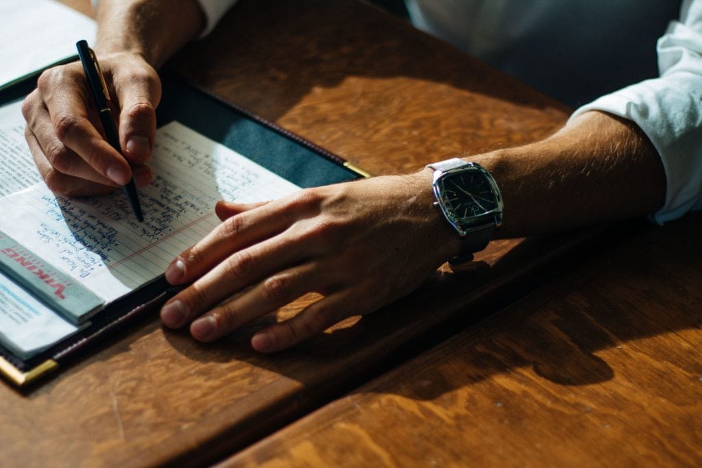 Man writing down his critical thinking skills to prepare for an interview