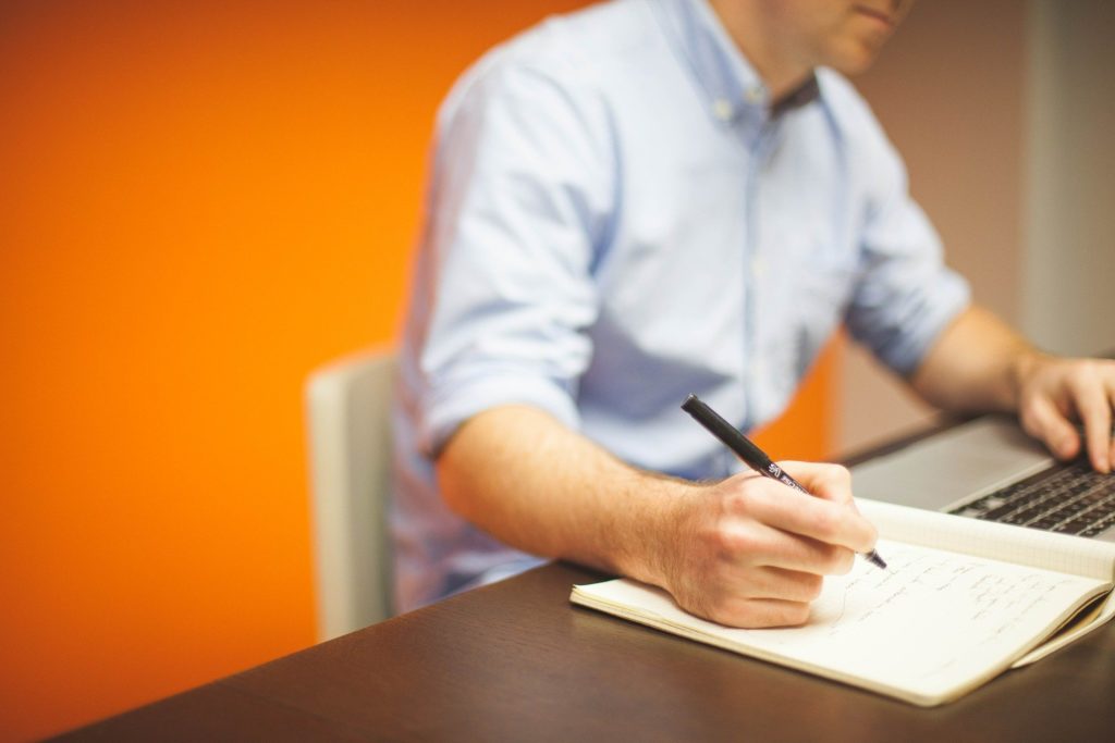 man making a list of possible career paths